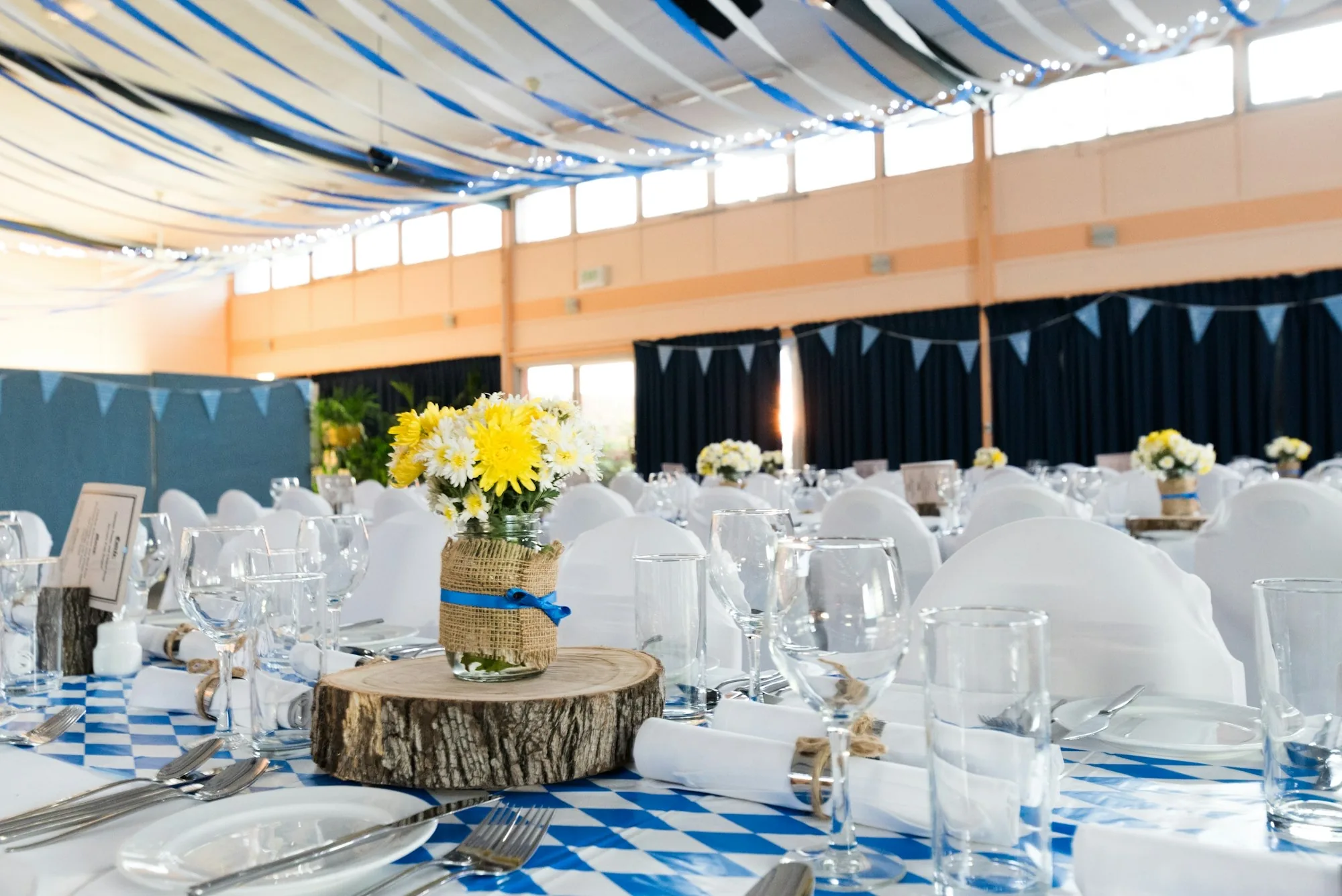 Reception hall set with round tables and soft lighting